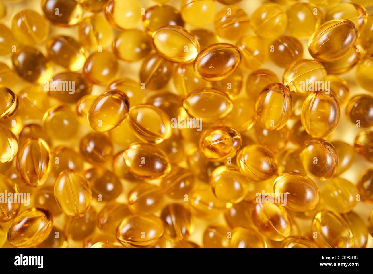 Soft yellow gelatin vitamin D capsules (top view close up Stock Photo