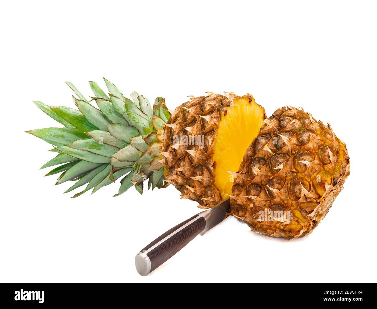 Two halves of pineapple and knife isolated on white background Stock