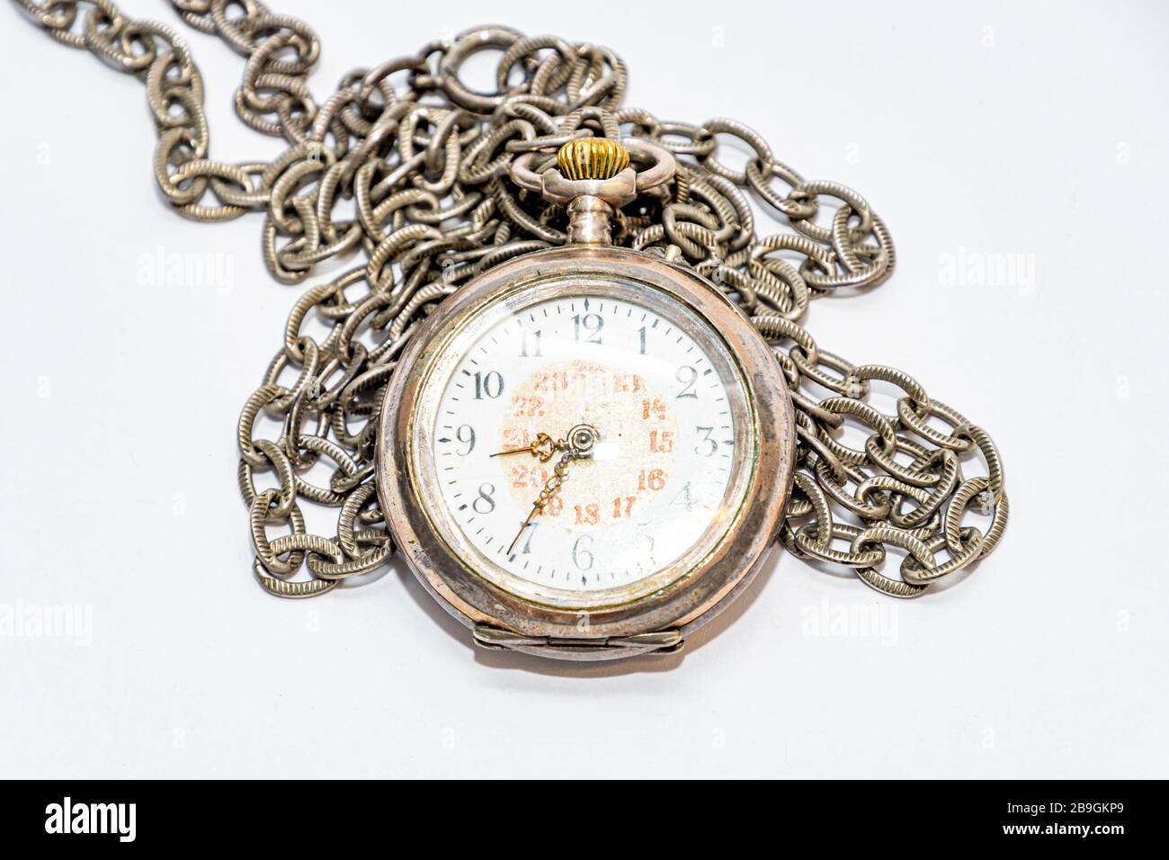 Old wind up pocket watch worn with silver a chain Stock Photo Alamy