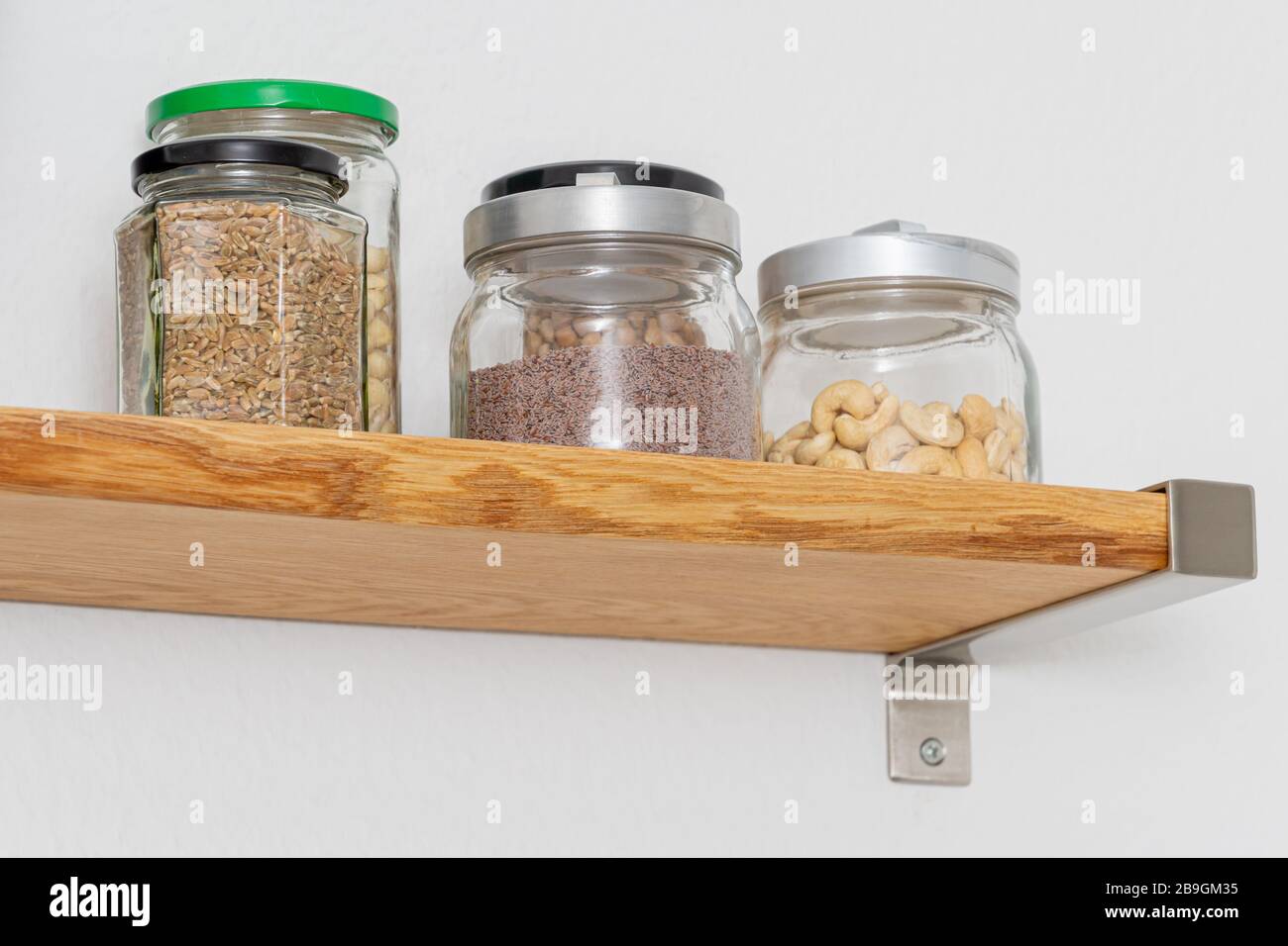 Shelves made by natural oak planks mounted with brushed steel attachment to wall Stock Photo Alamy