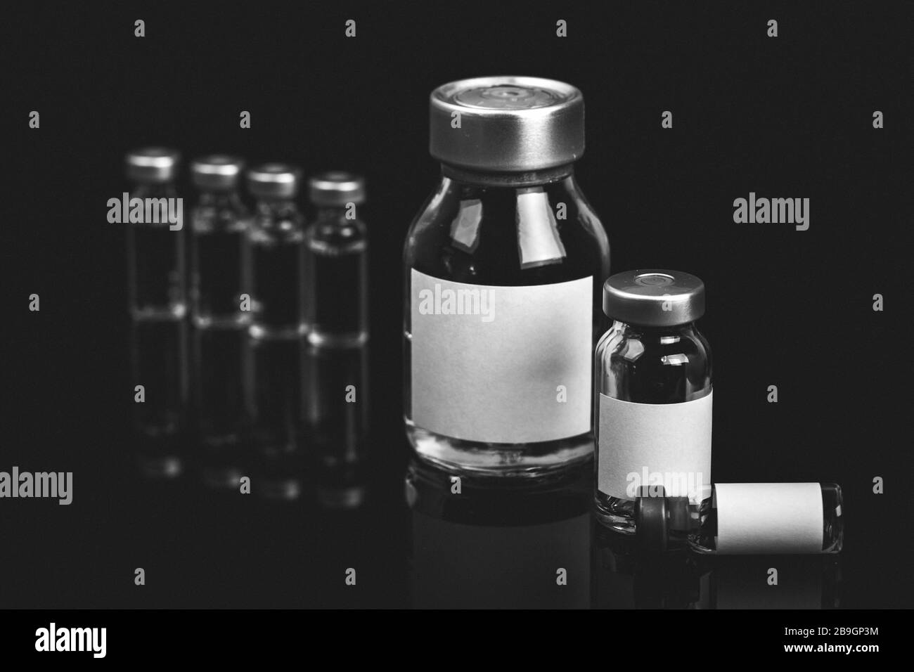 Different types of glass vial medical closeup isolated on a black