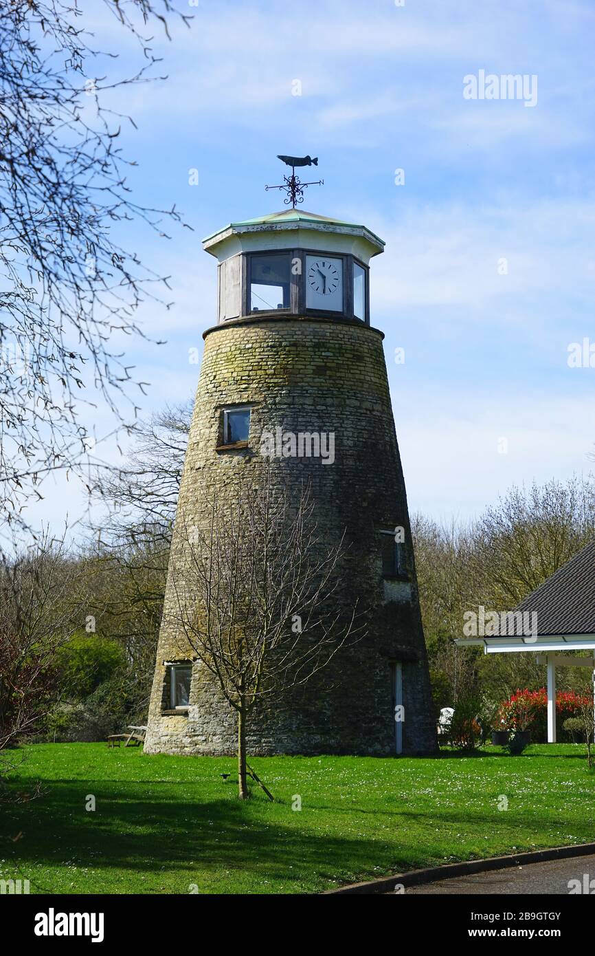 Old windmill converted into a clock tower at Sharnbrook Stock Photo