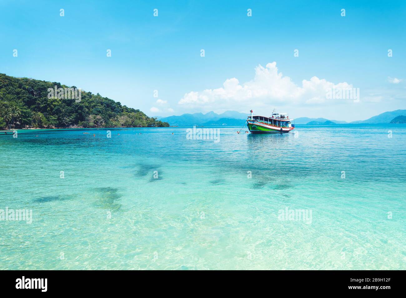 Clear water on the island,Bright blue sea and wooden boat Stock Photo ...