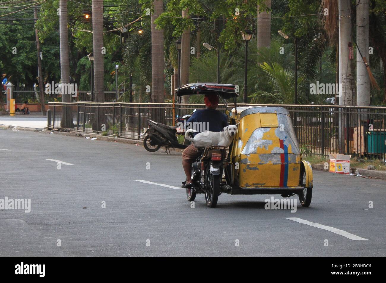 Manila, Philippines. 24th Mar, 2020. A solitary tricycle passes through General Luna Street in Manila, a week after an enhanced community lockdown was implemented in Luzon by the Philippine Government to combat the COVID-19 Virus threat. (Photo by Dennis Jerome Acosta/ Pacific Press) Credit: Pacific Press Agency/Alamy Live News Stock Photo