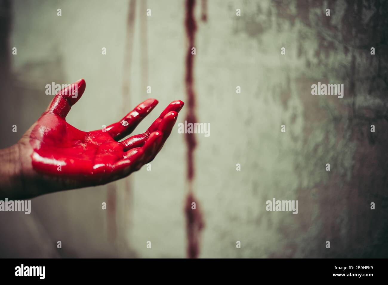 Close up of bloody hands in abandon house background. Horror and ghost concept. Criminal and murder concept. Halloween day and sacrifice theme. People Stock Photo