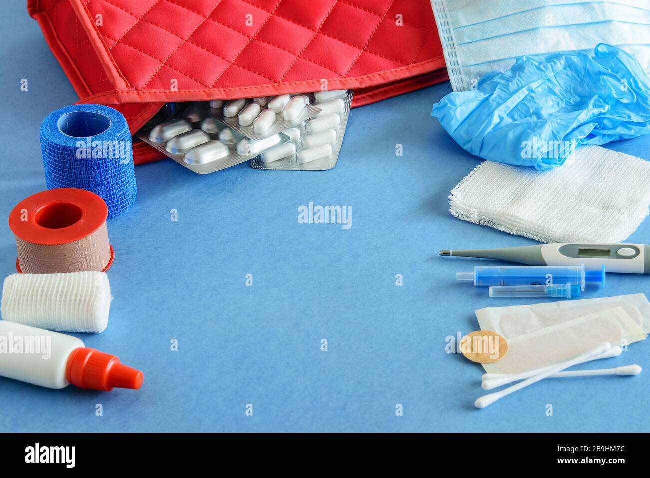 Minimum set of first aid kit on the blue background closeup. Flat  lay. Stock Photo