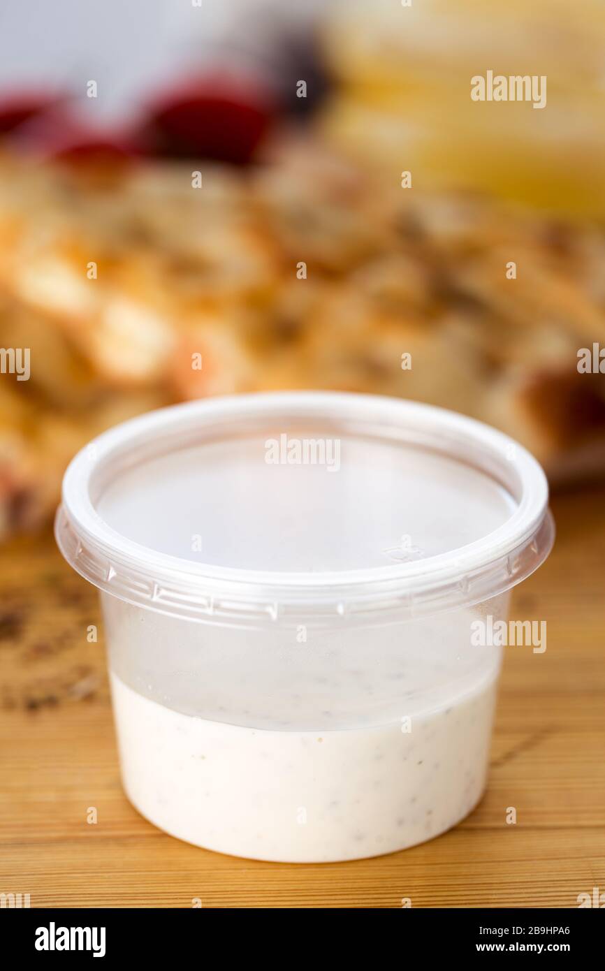 https://c8.alamy.com/comp/2B9HPA6/white-mayonnaise-dipping-sauce-in-plastic-container-shallow-depth-of-field-2B9HPA6.jpg