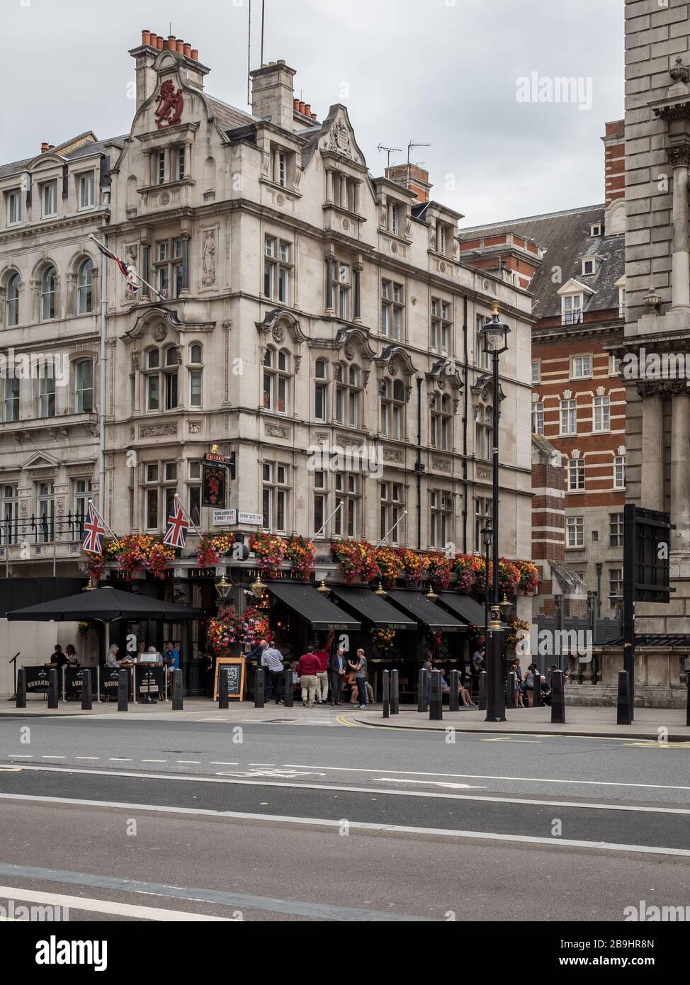 The Red Lion public house. Patrons outside a traditional English pub on Parliament Street in the heart of London's Whitehall district. Stock Photo