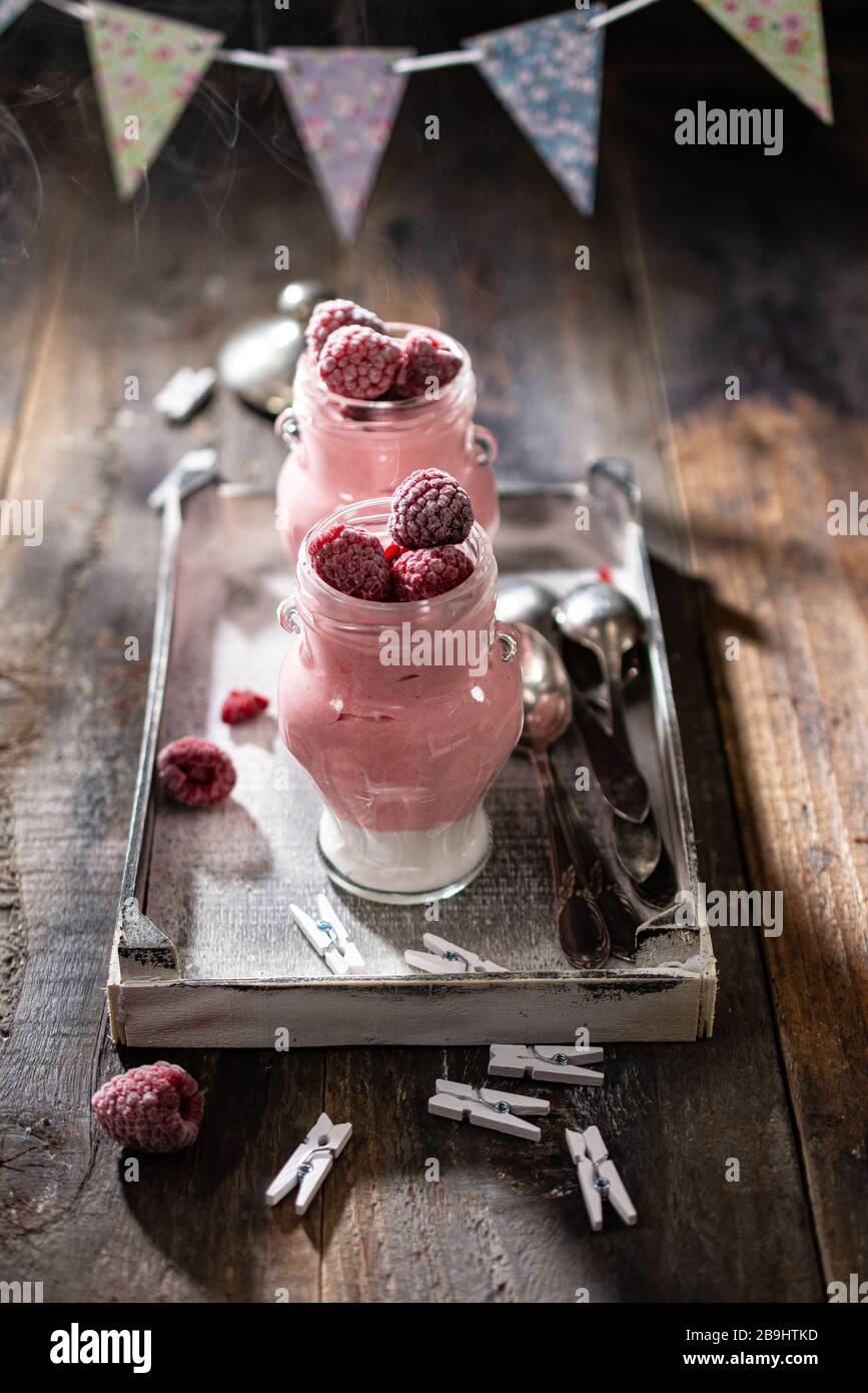 Creamy raspberry yogurt.Healthy fruit breakfast.Milk dessert in jars