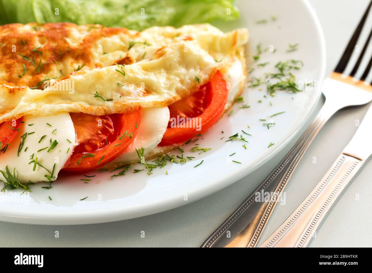 Tasty italian breakfast omelette with tomato and mozzarella Stock Photo