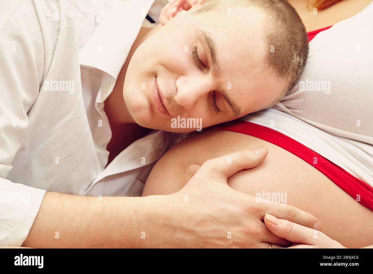 man hugging belly of his pregnant wife Stock Photo