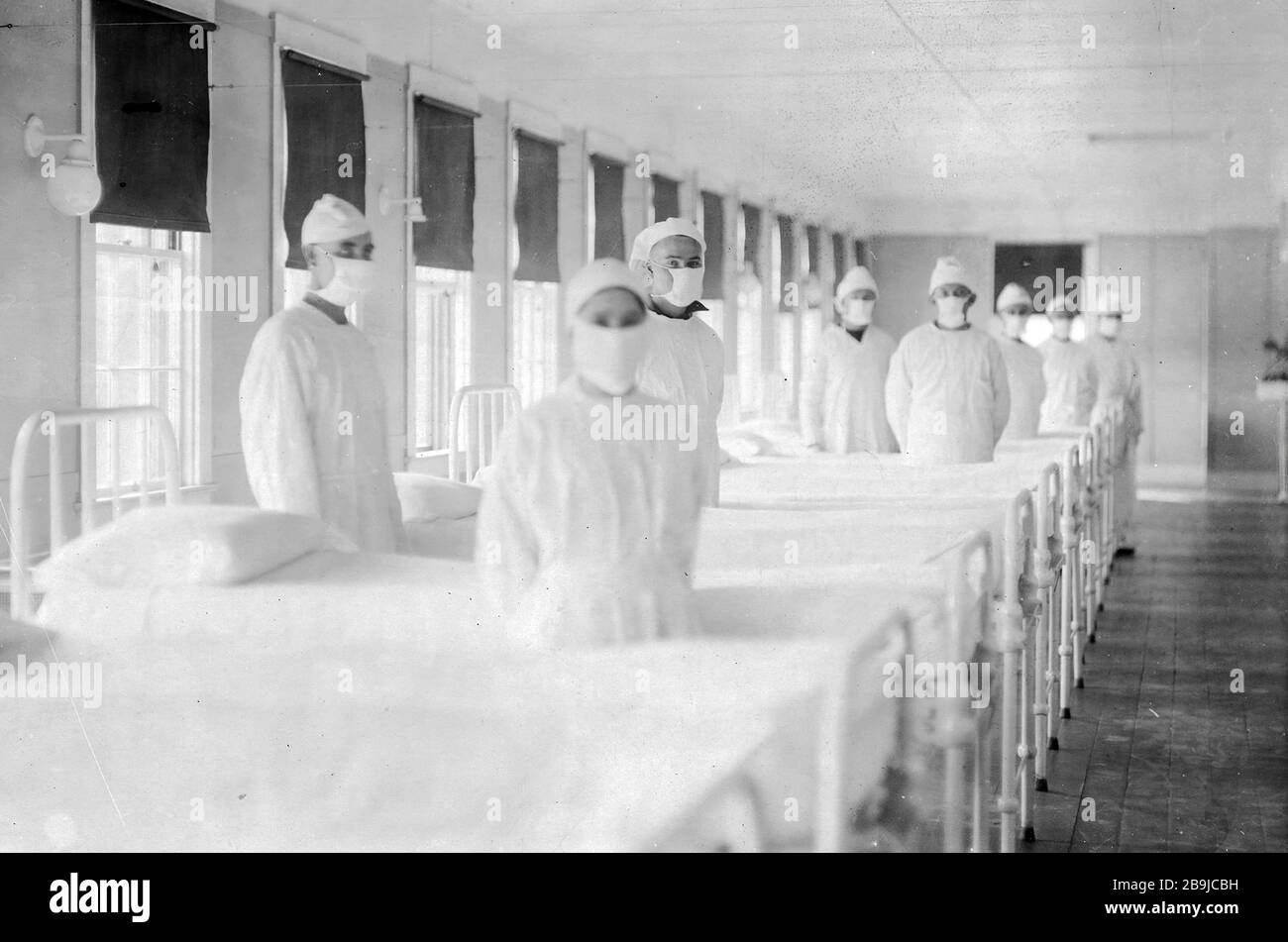 U.S. Naval Hospital. Corpsmen in cap and gown ready to attend patients in influenza ward. Mare Island, California, 12/10/1918. (U.S. Navy) 1918-1919. An epidemic of 'Spanish Flu' spread around the world. At least 20 million died, although some estimates put the final toll at 50 million. Stock Photo