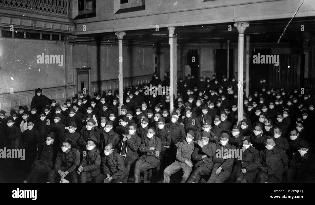 U. S. Army Hospital Number 30, Royat, France: Patients at moving picture show wearing masks because of an influenza epidemic. 1918-1919. An epidemic of 'Spanish Flu' spread around the world. At least 20 million died, although some estimates put the final toll at 50 million. Stock Photo