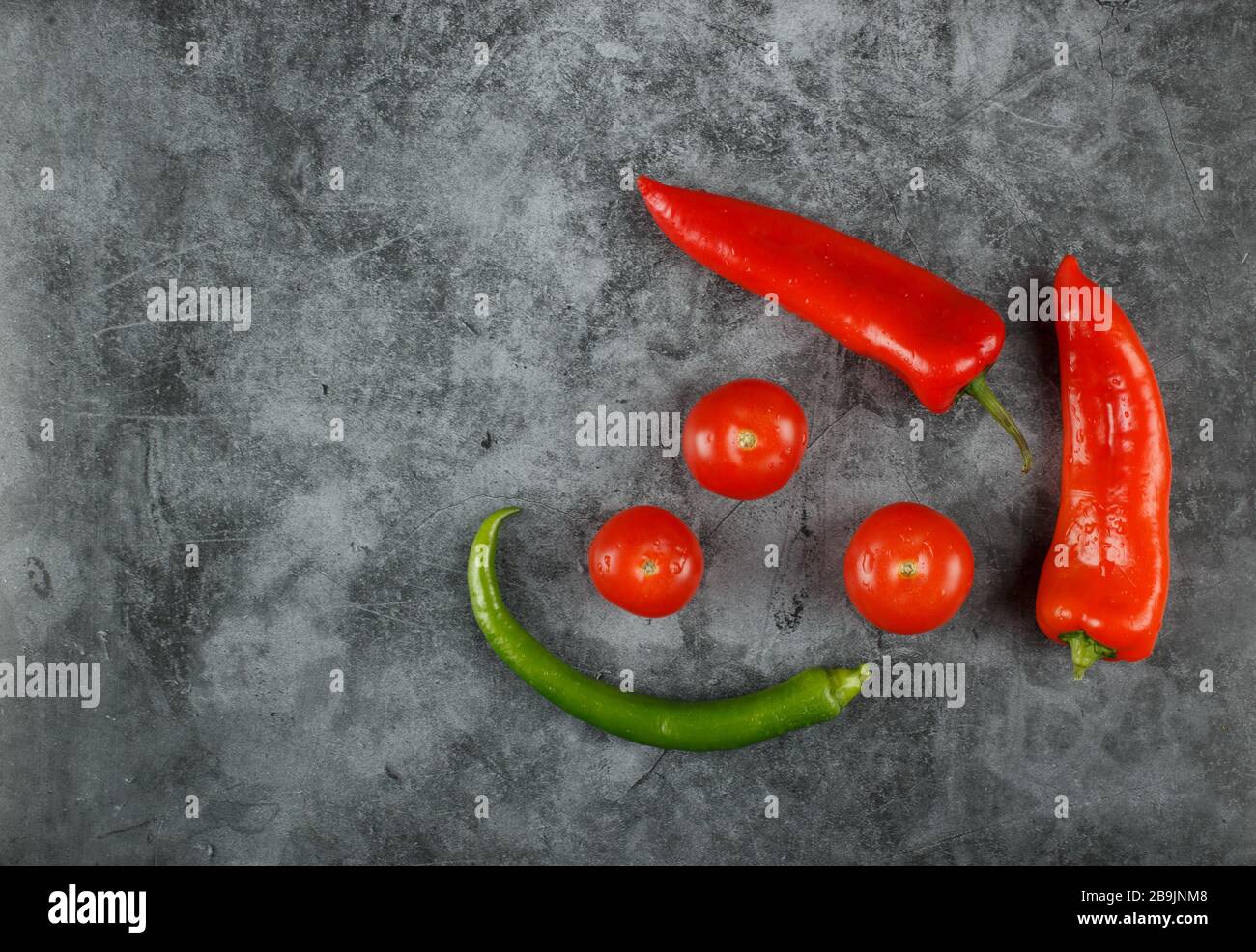 Red, green chilies with tomatoes. Top view. Stock Photo