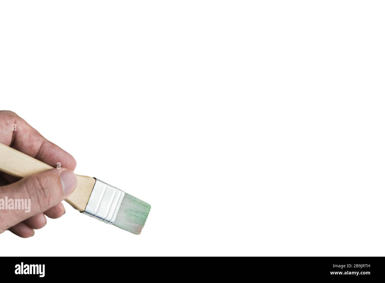 Hand holding paint brush on spiral notebook. Stock Photo