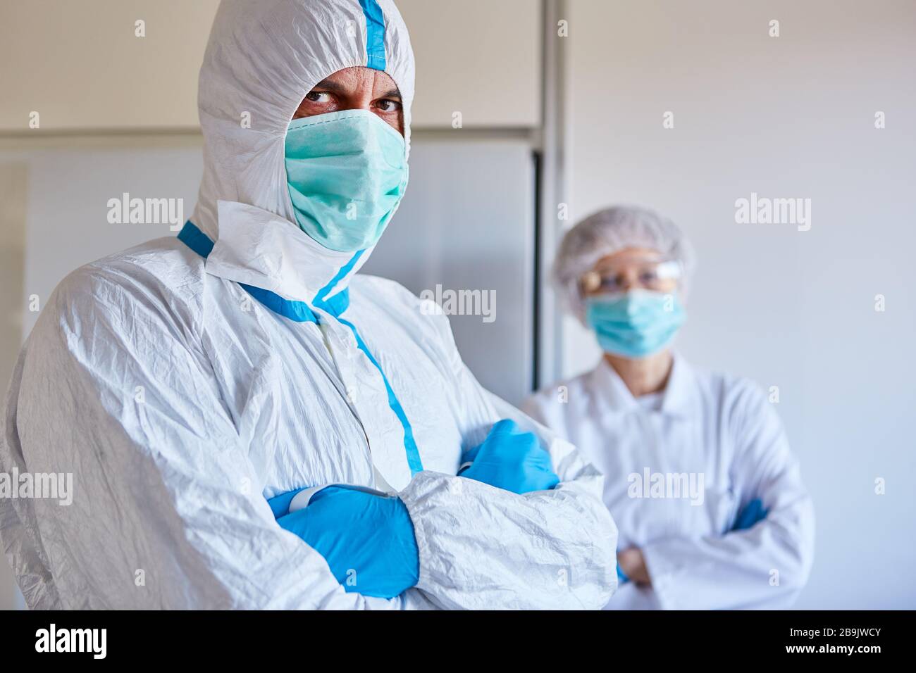 Two doctors in protective clothing in a clinic during Covid-19 epidemic (coronavirus) Stock Photo