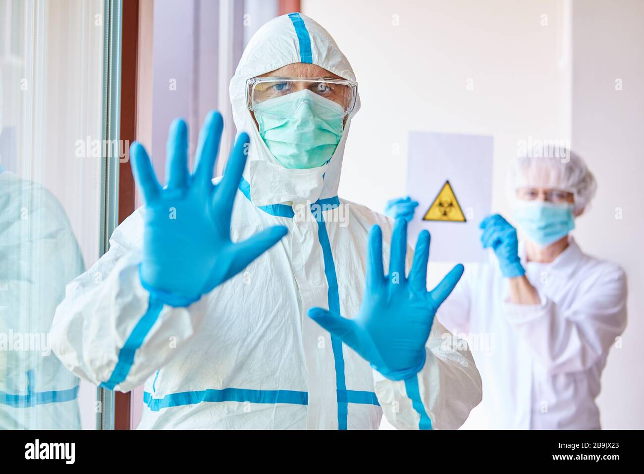 Doctors in protective clothing enforce ban on visits to clinic because of Covid-19 epidemic Stock Photo