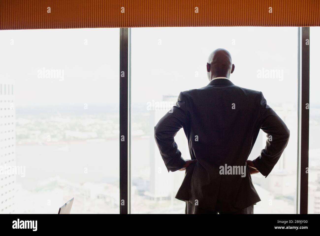 Man looking through window Stock Photo