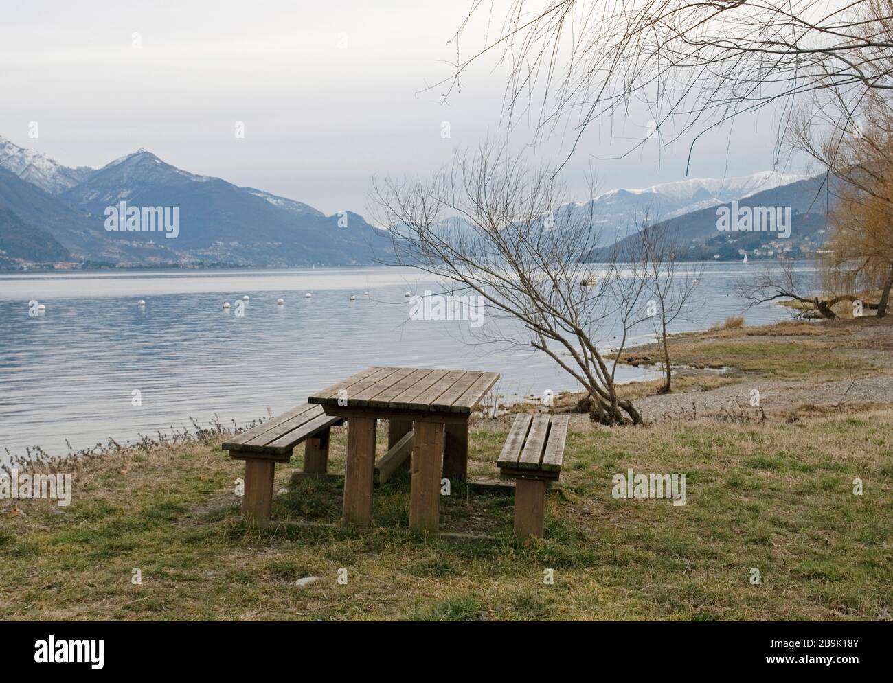 picnic table on the shore of Lake Como during the winter season, Italy Stock Photo