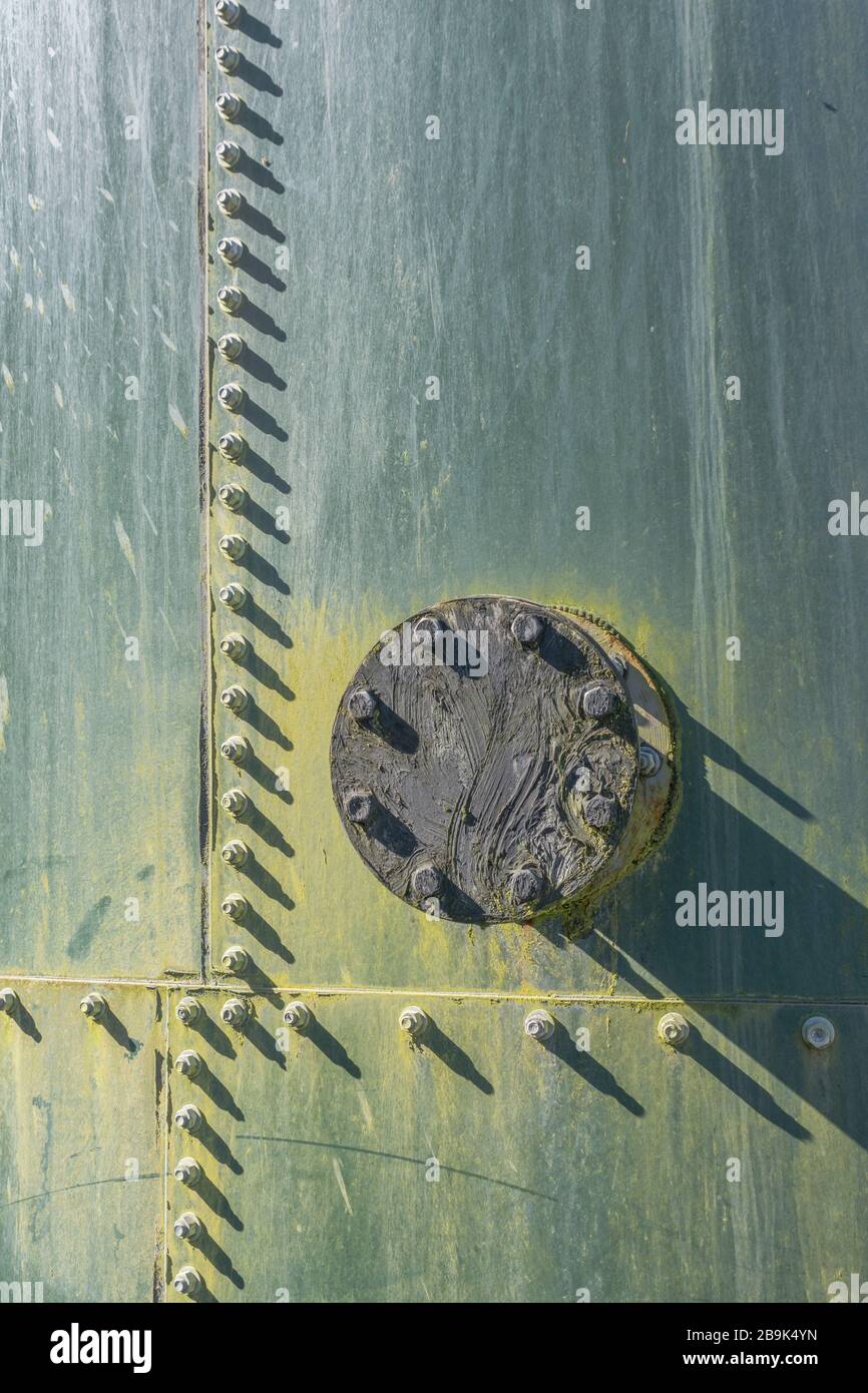 Nuts and bolts on an industrial metal tank of some description
