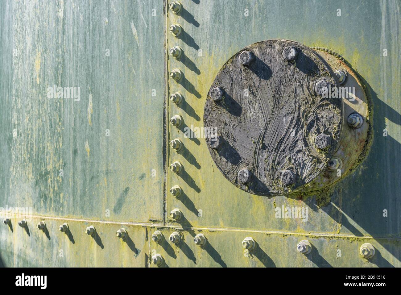 Nuts and bolts on an industrial metal tank of some description