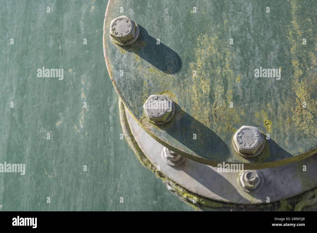Nuts and bolts on an industrial metal tank of some description