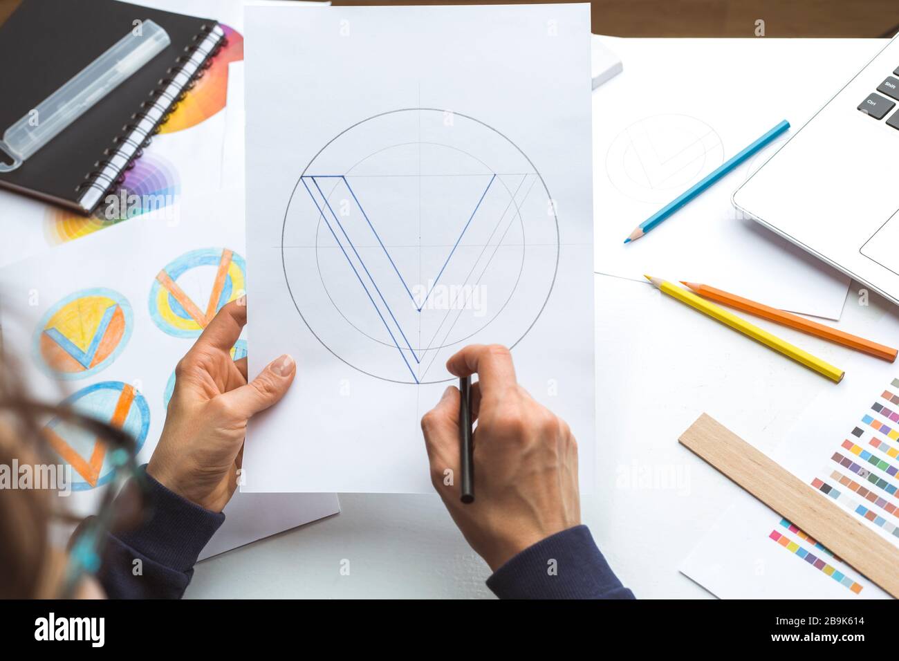Designer draws a sketch of a brand logo. Stock Photo