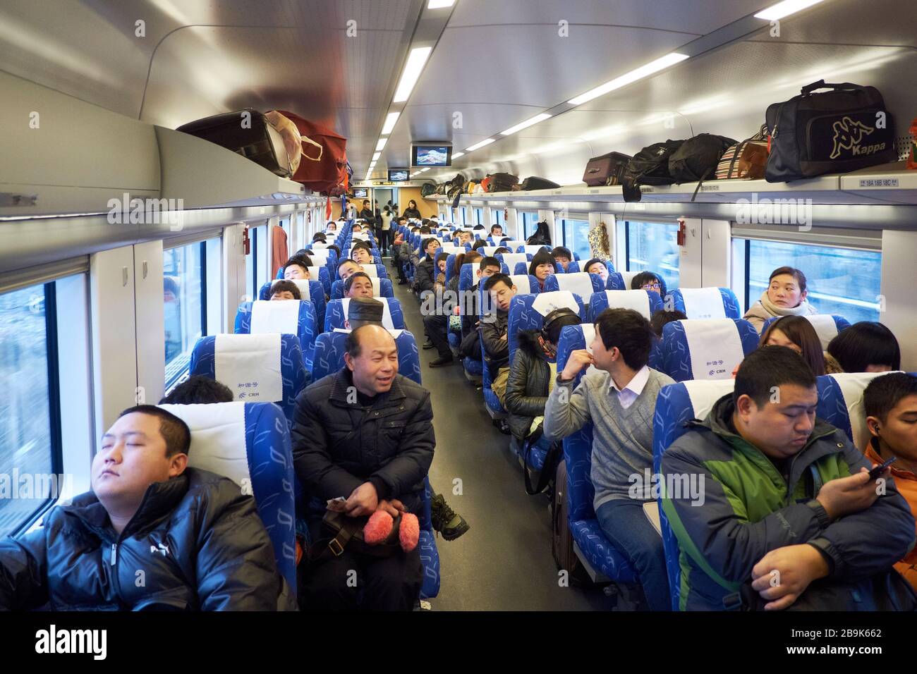 The interior of a full carriage on the Chinese high speed railway system. Stock Photo