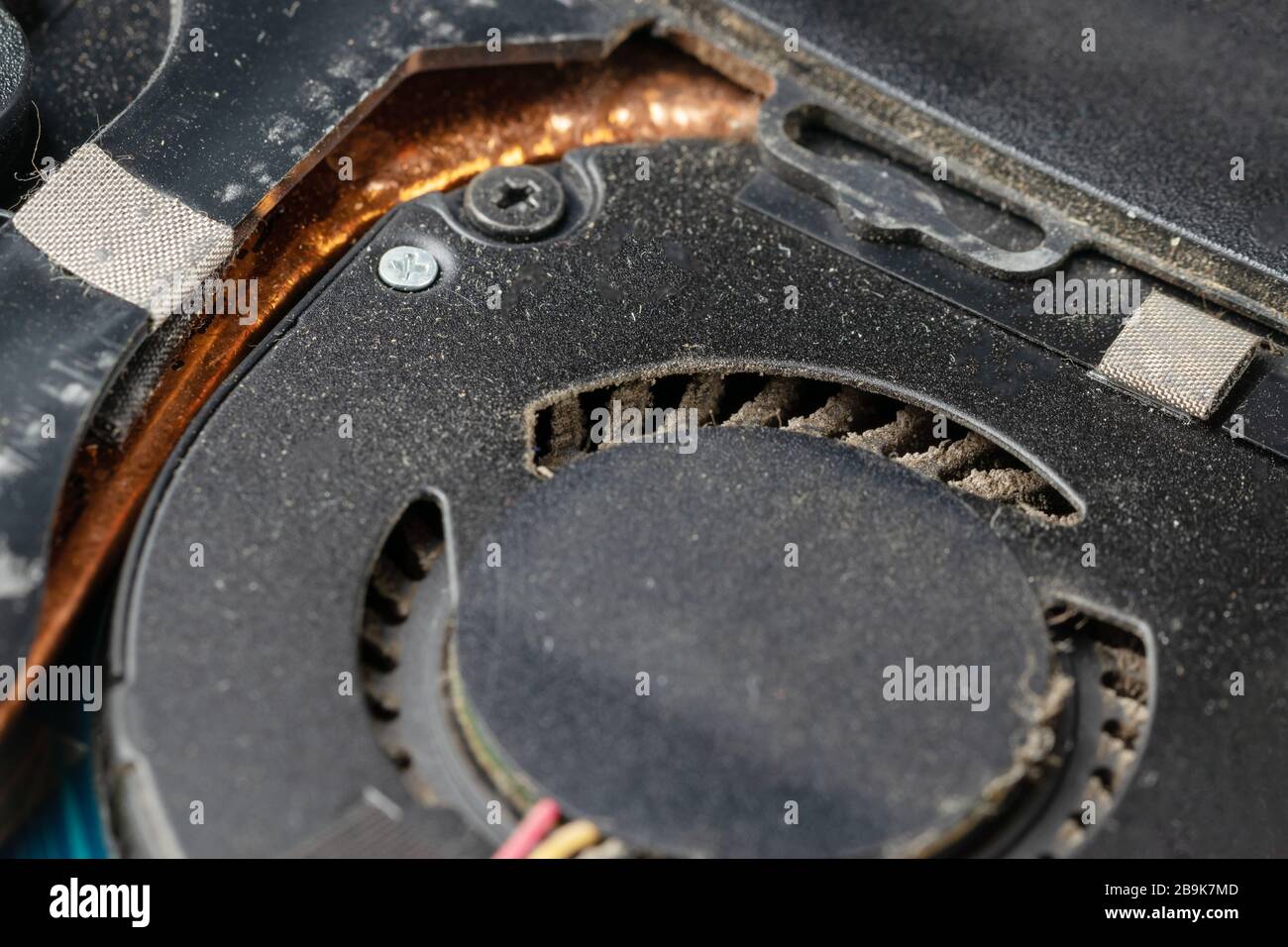 Very dirty, dusty laptop cooling system inside. Notebook with cover removed for cleaning and repair. Stock Photo
