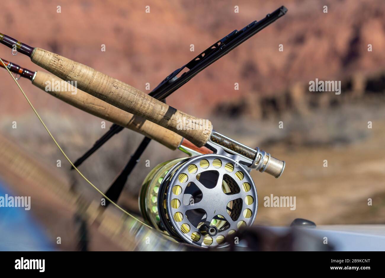 Two flu fishing rods with reels on front windshield of parked truck in the Southwest, USA. Stock Photo