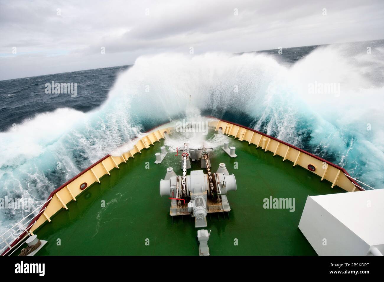 Breakers crash onto the deck of a ship on a stormy day. Stock Photo