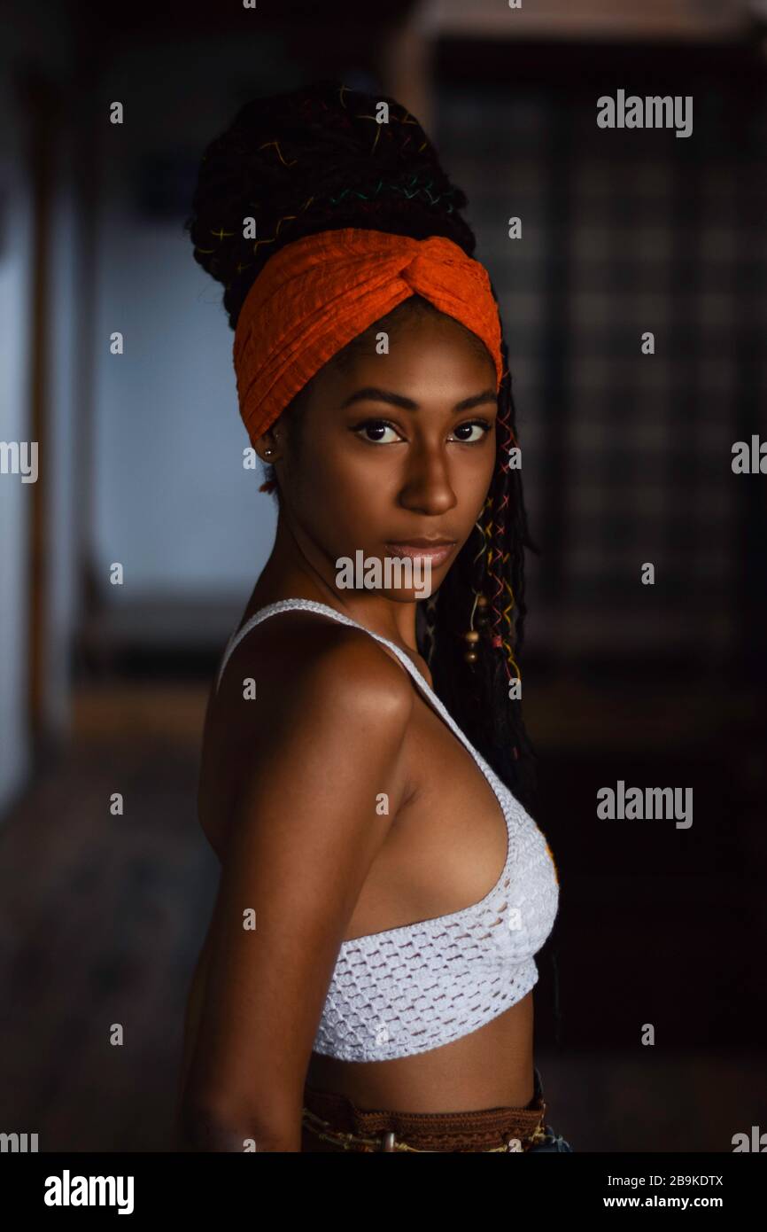 Interior portrait of young latin woman with dreadlocks Stock Photo