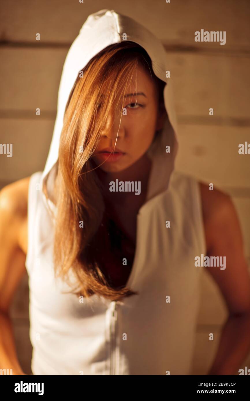 Woman wearing hooded sweatshirt hi-res stock photography and images - Alamy