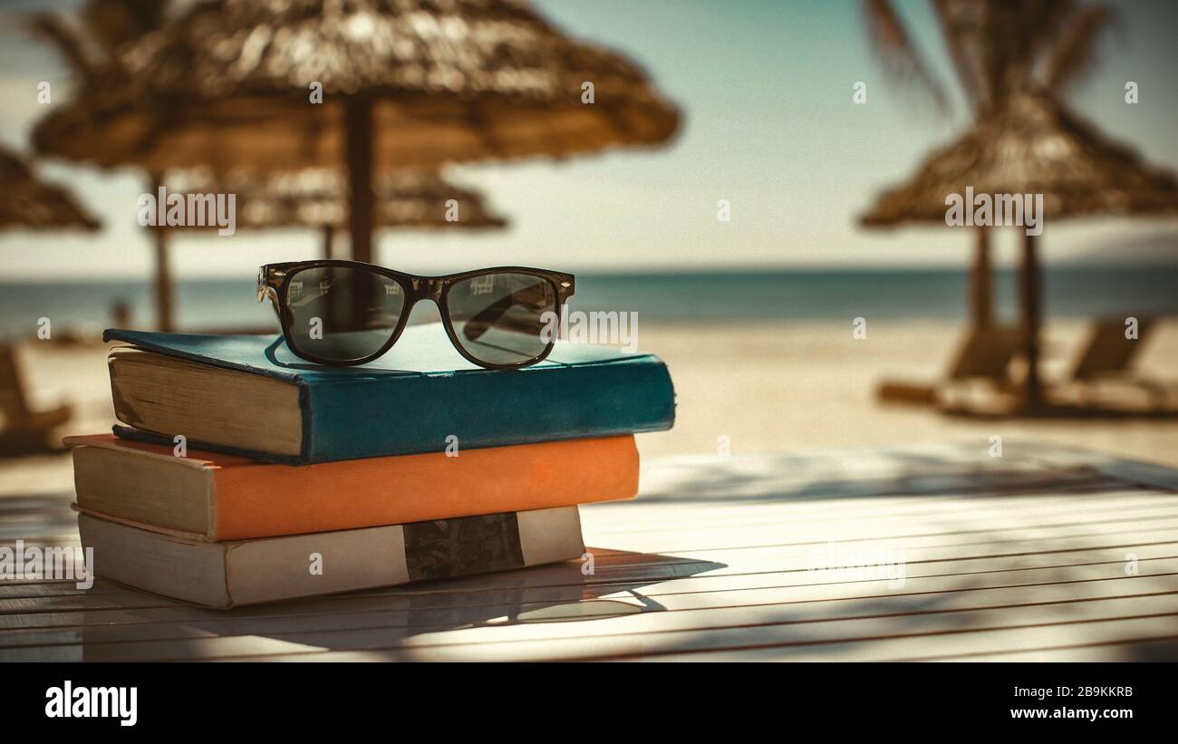 Reading in the tropics beach Stock Photo