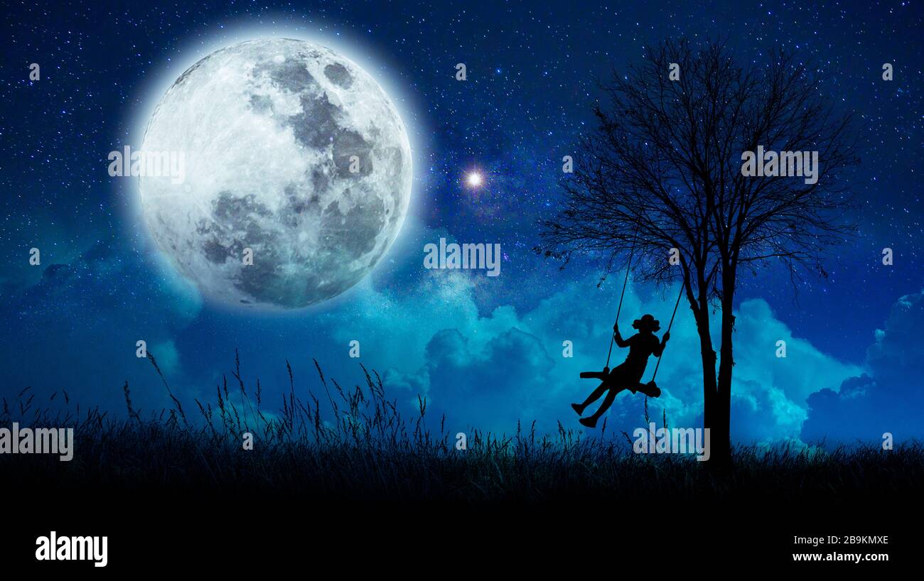 imagination The girls are cradling amidst many stars and full moon at night. Stock Photo