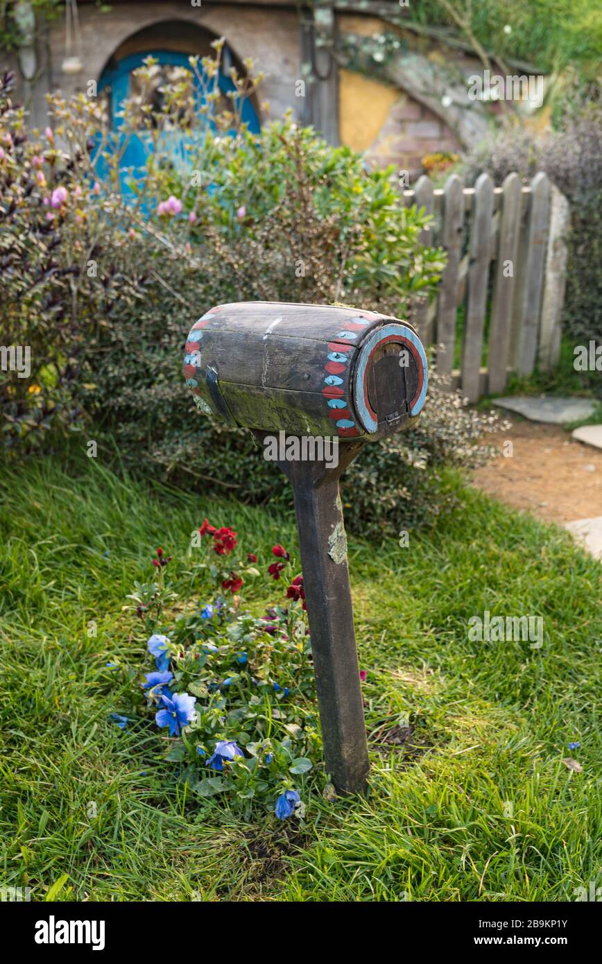 A painted wooden letterbox for a hobbit hole at the Hobbiton Movie Set, New Zealand Stock Photo