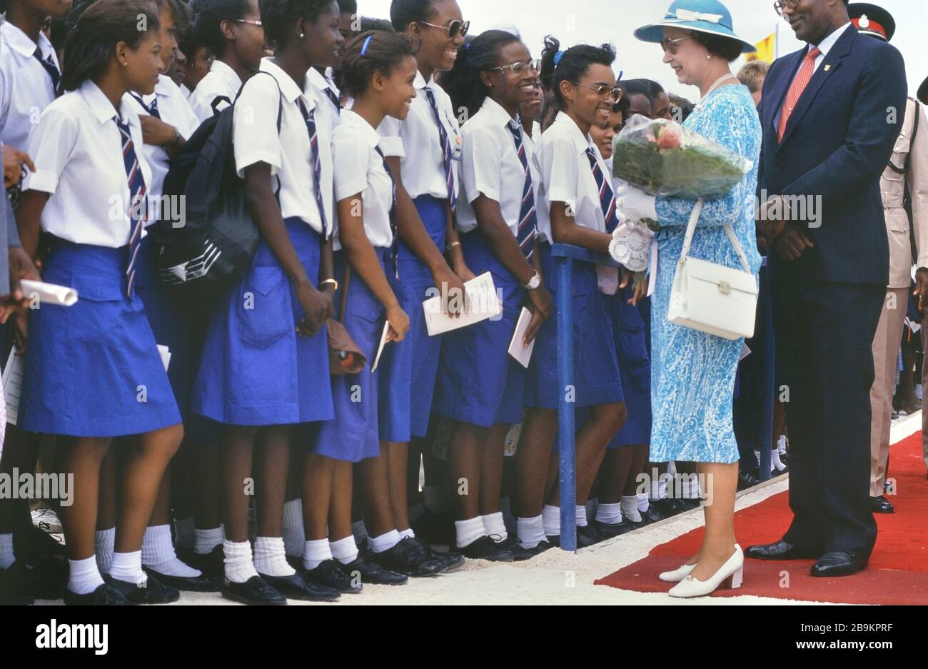 Queen Elizabeth II visit to Queen's College to officiate at a stone laying ceremony for the new school building. Barbados, Caribbean. 1989 Stock Photo