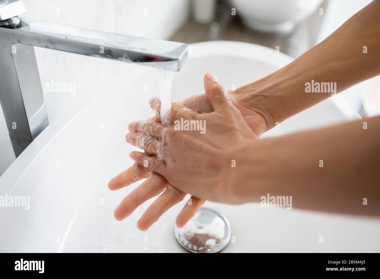 After toilet woman wash her arms using antibacterial soap closeup Stock Photo