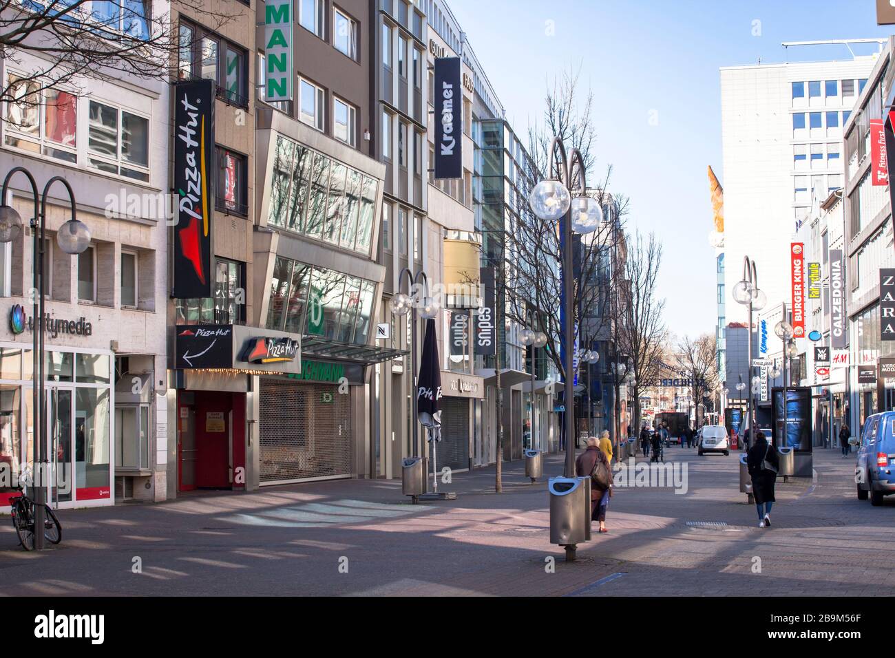 Coronavirus / Covid 19 outbreak, March 24th. 2020. Only few people on shopping street Schildergasse, usually visited by thousands of people, Cologne, Stock Photo