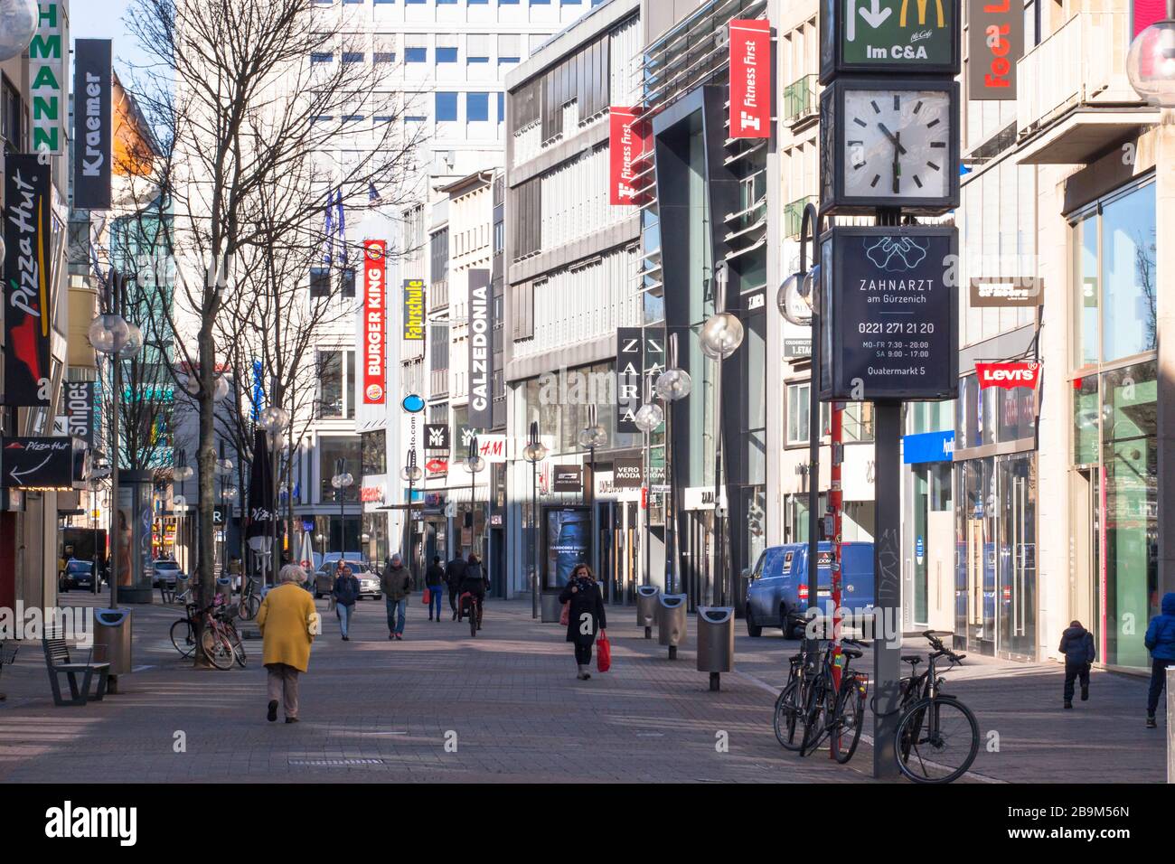 Coronavirus / Covid 19 outbreak, March 24th. 2020. Only few people on shopping street Schildergasse, usually visited by thousands of people, Cologne, Stock Photo