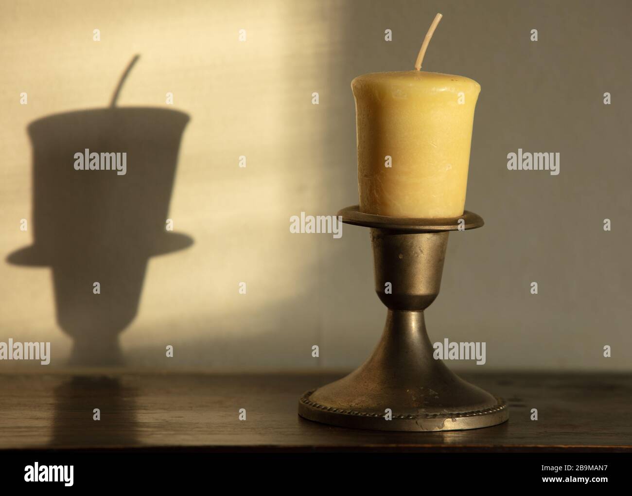 Candle seen in early morning sun Stock Photo Alamy