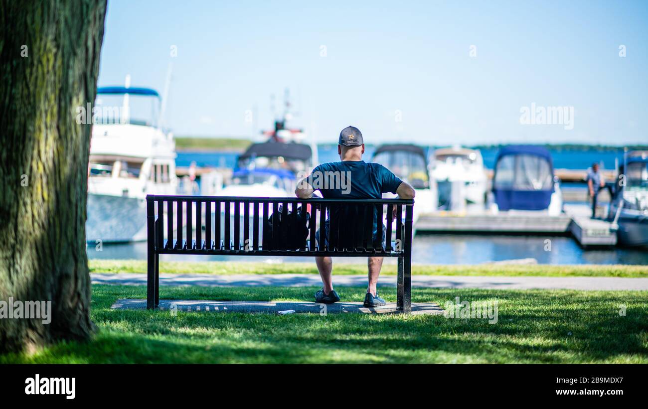 Man sitting on lake shore hi-res stock photography and images - Alamy