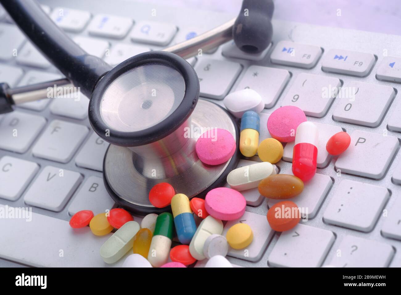 stethoscope, pill on keyboard, close up  Stock Photo