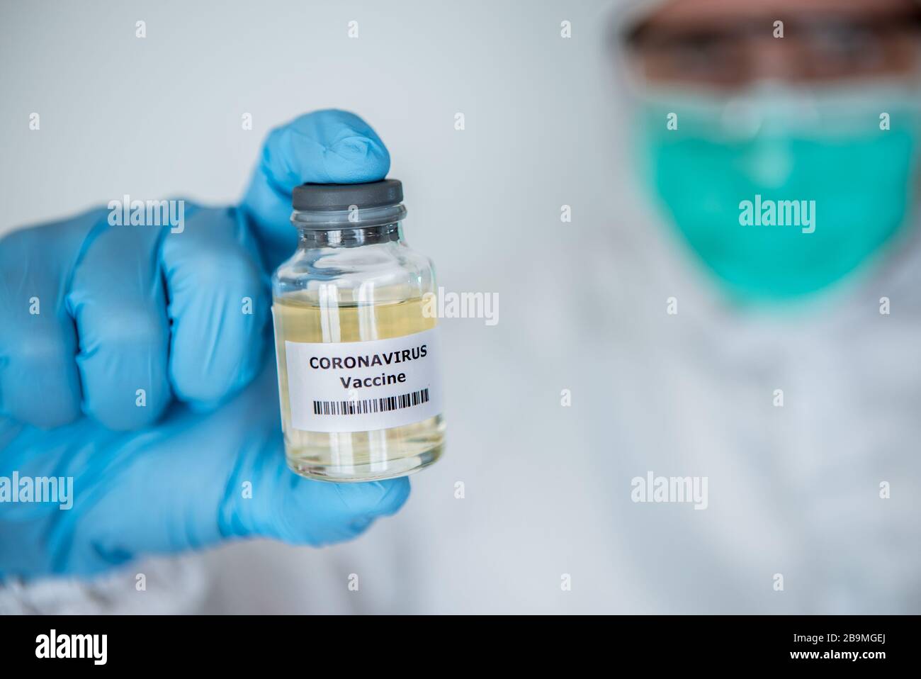 Male scientific on protective suit with a vaccine vial coronavirus, medical concept caucasian man with vaccination covid-19 injection treatment diseas Stock Photo