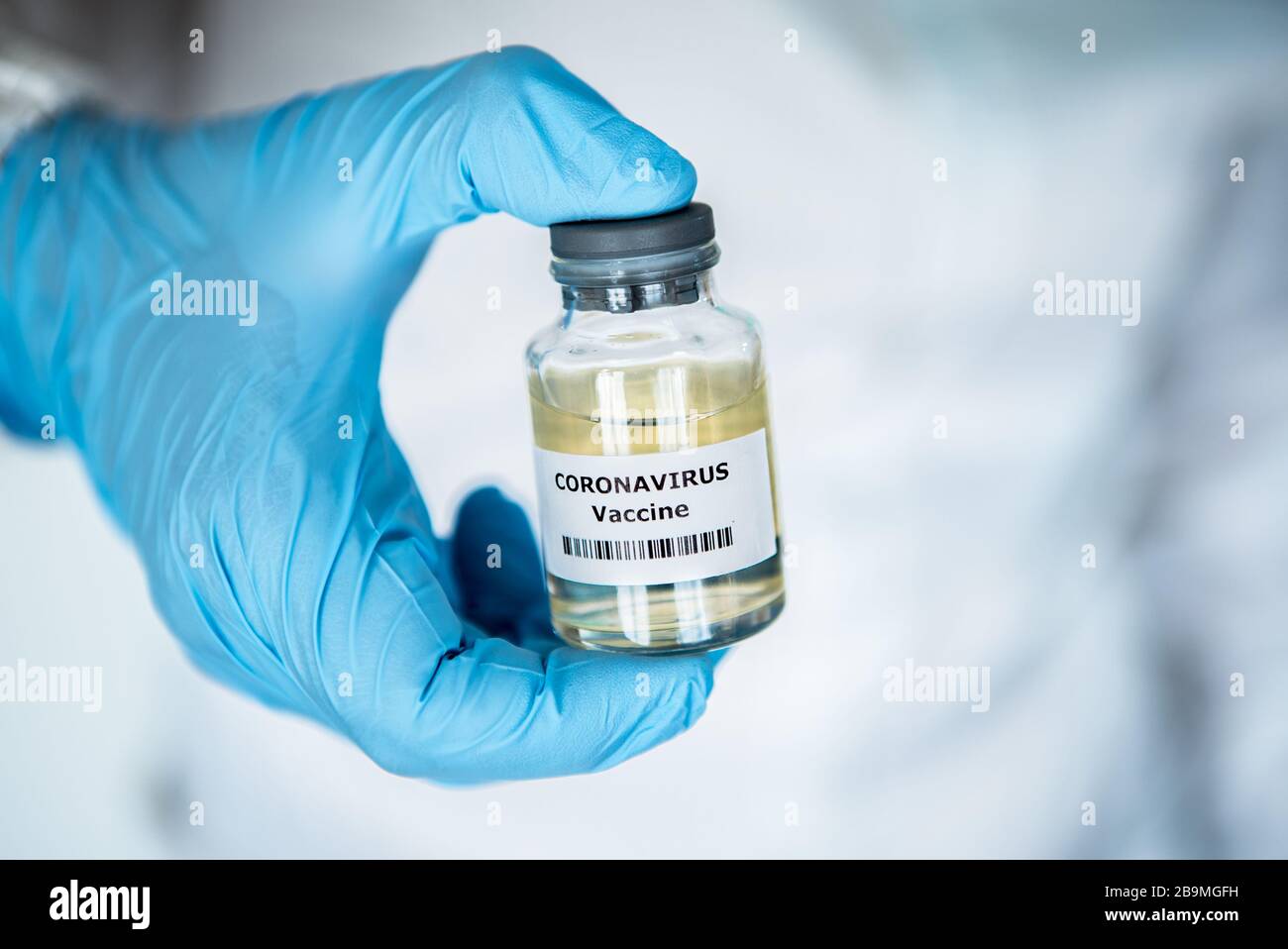Scientific with protective suit holds a vaccine for coronavirus. Vaccination for COVID-19. 2019-nCoV found in Wuhan China. Epidemic virus outbreak con Stock Photo
