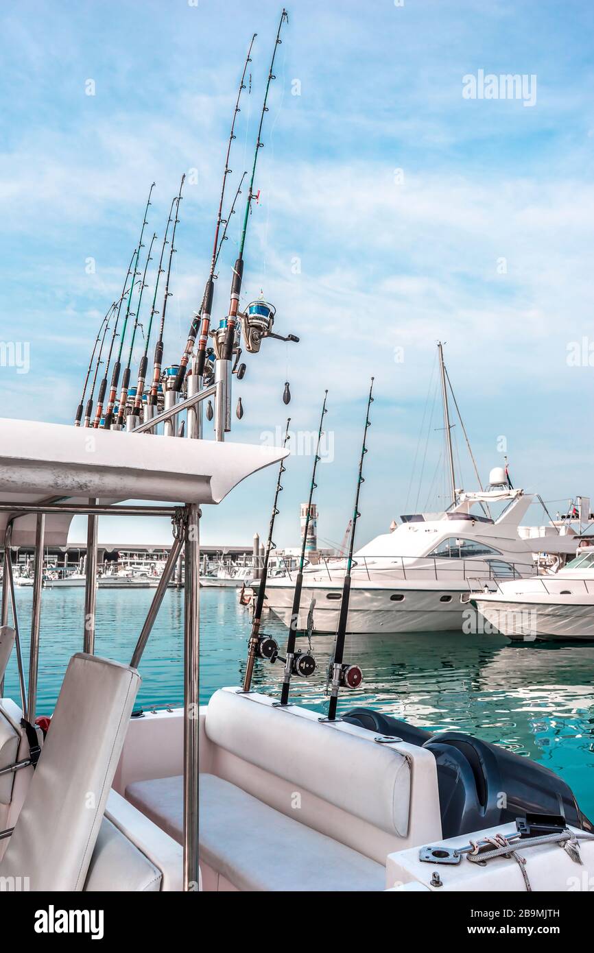 White yachts with fishing rods in a turquoise lagoon for tourist