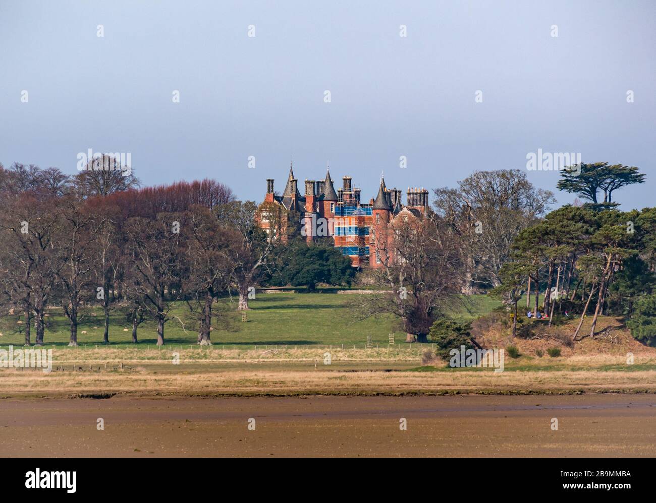 Tyninghame House Scots baronial mansion seen across Tyne estuary, John Muir Country Park, East Lothian, Scotland, UK Stock Photo
