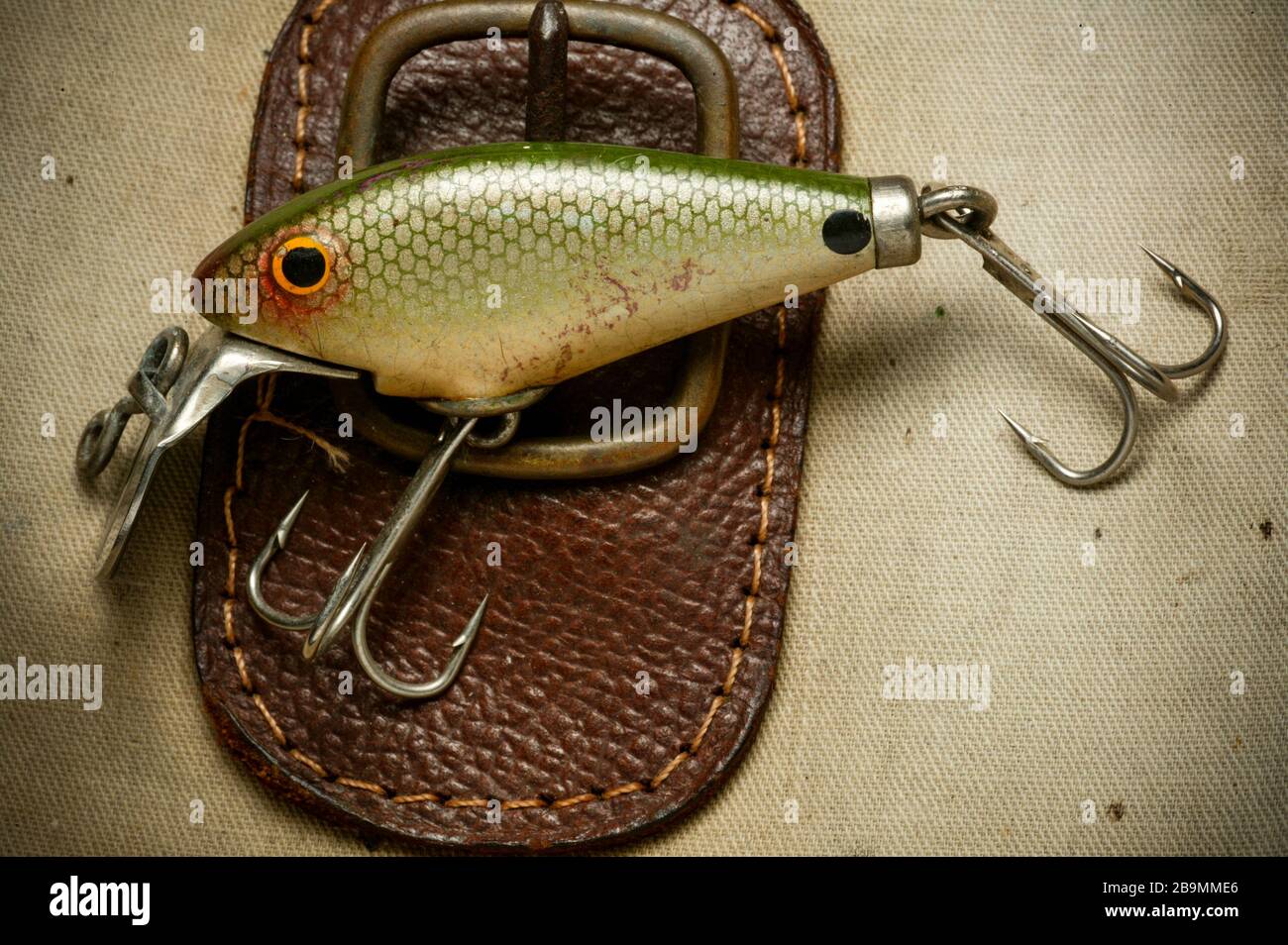 https://c8.alamy.com/comp/2B9MME6/an-example-of-a-vintage-fishing-lure-equipped-with-treble-hooks-possibly-made-by-woods-mfg-displayed-on-an-old-fishing-bag-lures-such-as-these-are-2B9MME6.jpg