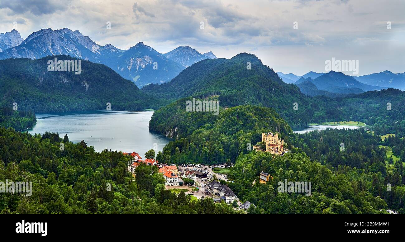 Hoehenschwangau castle with Alpsee left and Schwansee right and Alps in the background. Stock Photo