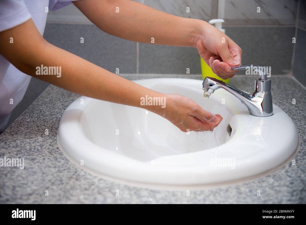 Woman wash hand cleaning with soap in the sink, Disinfection to stop the coronavirus or prevent the spread of the Covid 19 outbreak, Good hygiene prot Stock Photo